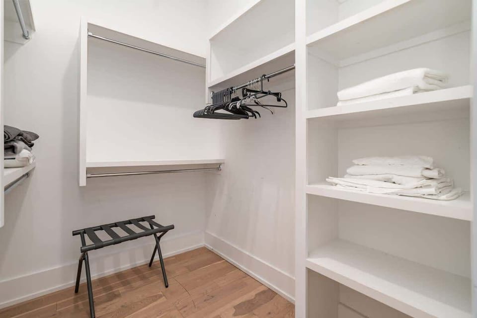 Primary bathroom with double vanities, a large walk-in shower, and a large walk-in closet.