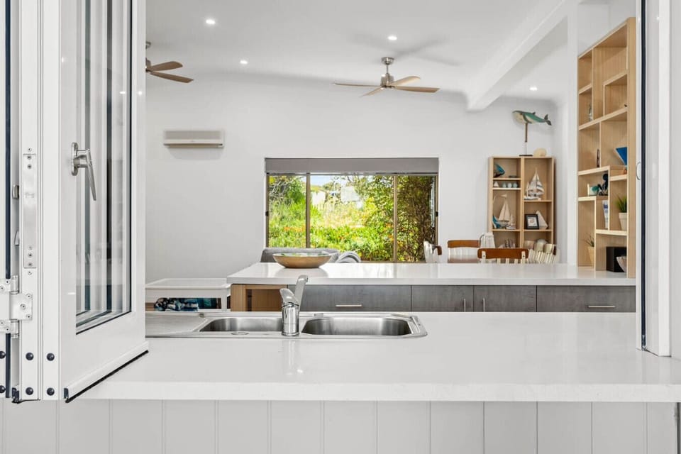 A servery opens directly from the kitchen to the outdoor deck and patio—providing a seamless connection to indoor and outdoor spaces.