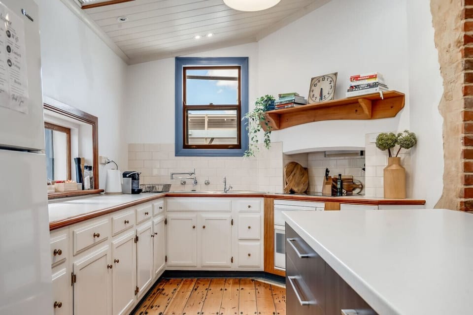 Prepare meals in the bright, thoughtfully designed kitchen, where classic details meet everyday functionality.