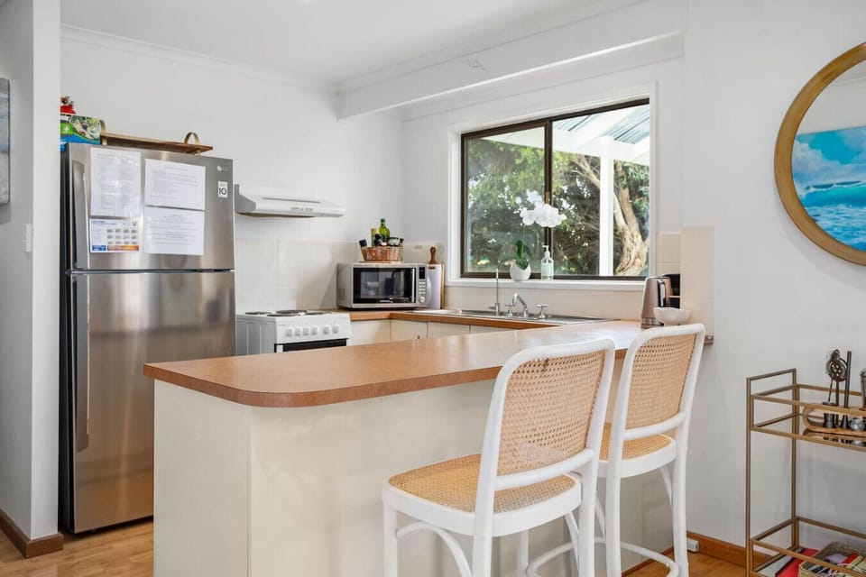 The well-equipped kitchen offers everything needed for effortless home dining, with modern appliances, ample bench space, and a Nespresso machine for your morning coffee ritual.