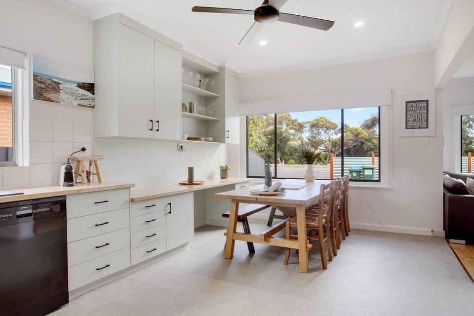 Share meals at the long timber dining table, where soft light creates the perfect setting for slow breakfasts or relaxed dinners.