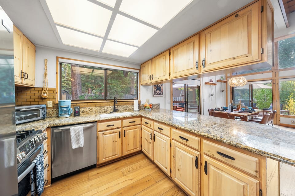 Bright kitchen featuring wood ceilings and plenty of counter space.