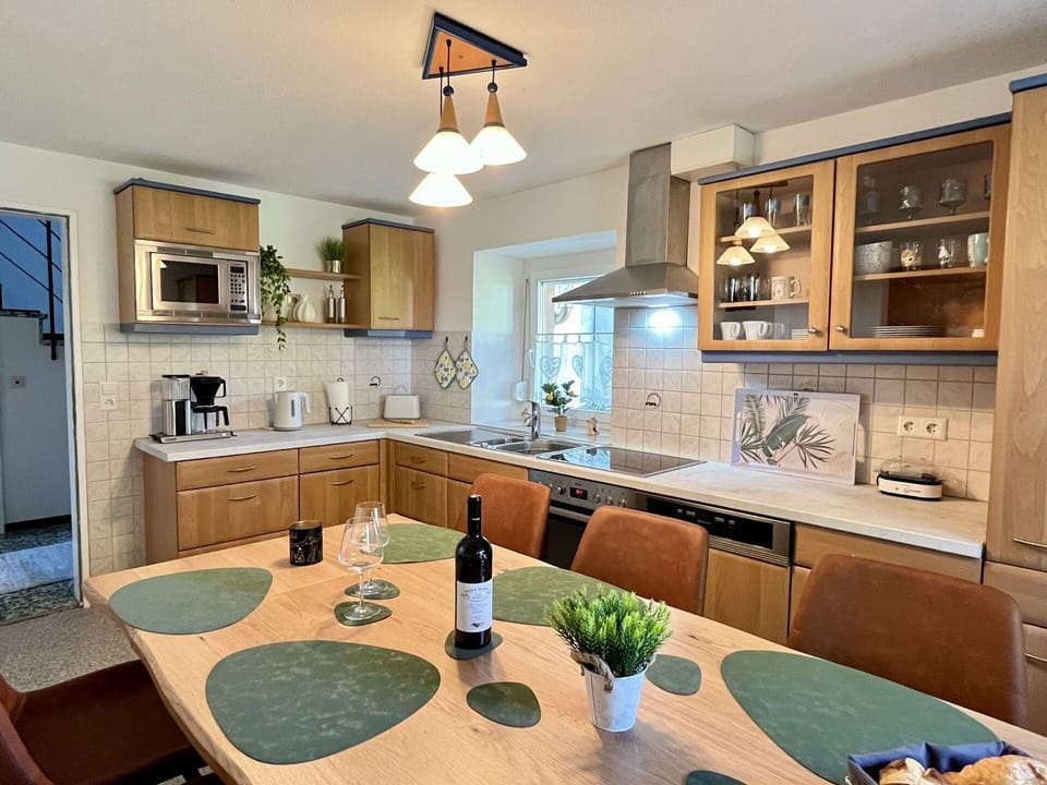 Furniture, Kitchen, Countertop, Interior Design, Cabinetry, Kitchen Appliance, Light Fixture, Wood, Flooring, Ceiling