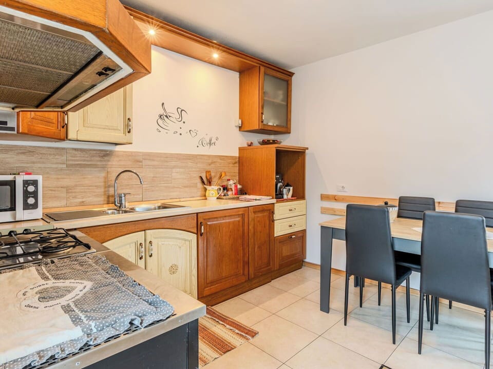 Furniture, Flooring, Interior Design, Wood, Cabinetry, Countertop, Floor, Kitchen, Room, Major Appliance