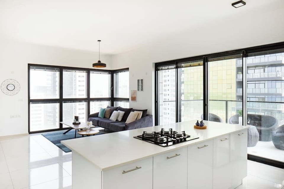 Open-plan design connects kitchen and living space, making the apartment feel spacious and inviting.