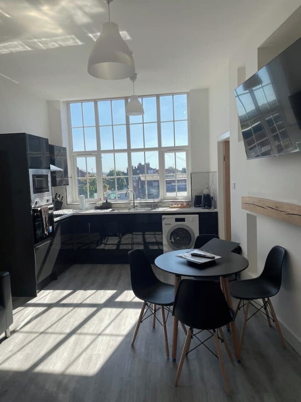 Open plan kitchen dining area with TV