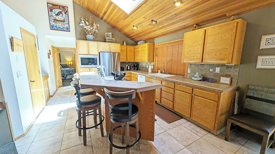 The Kitchen with Bar Seating and S/S appliances