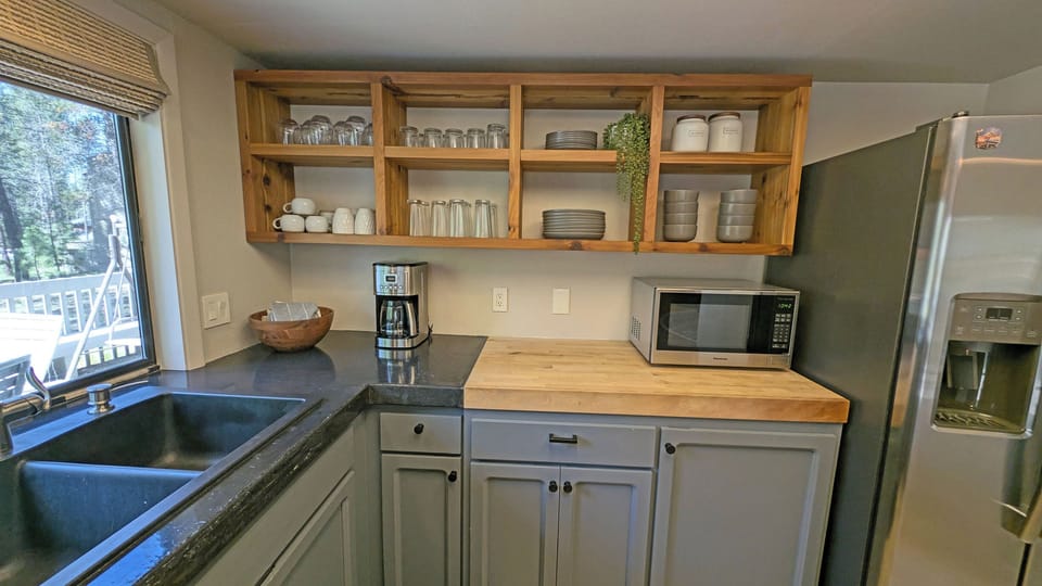 Open cupboards and a Butcher Block counter space lend that modern feel