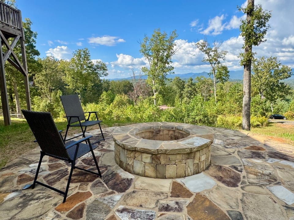 Fire Pit Retreat: Gather around the stone fire pit and savor breathtaking mountain views!