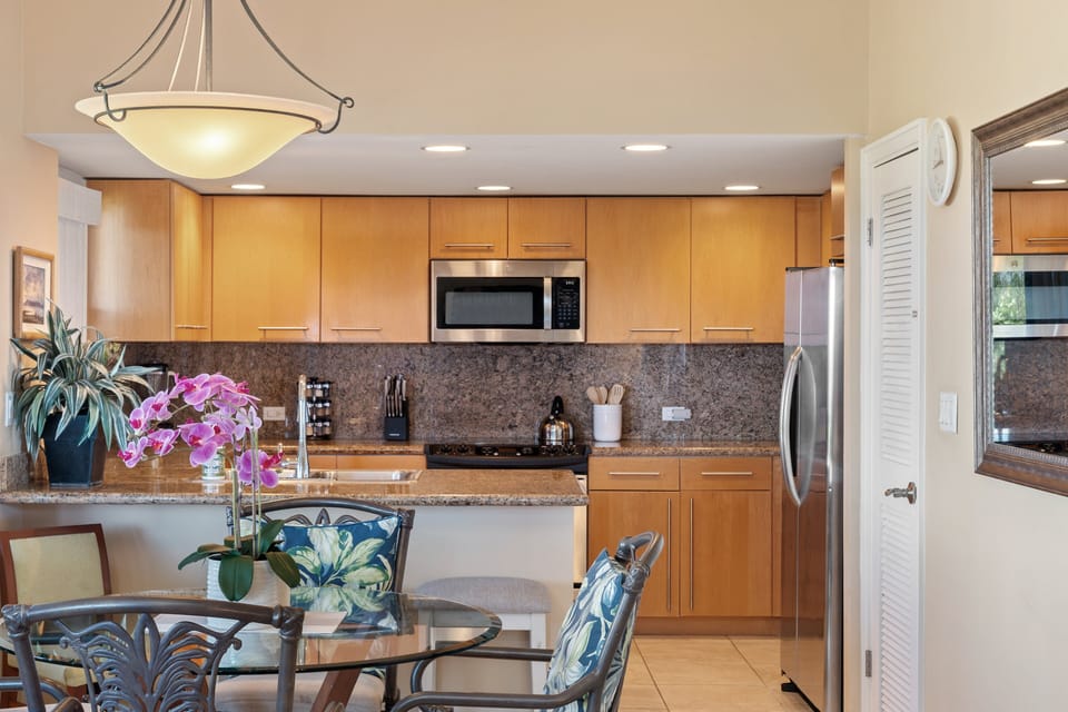 Open kitchen with granite surfaces, stainless steel appliances