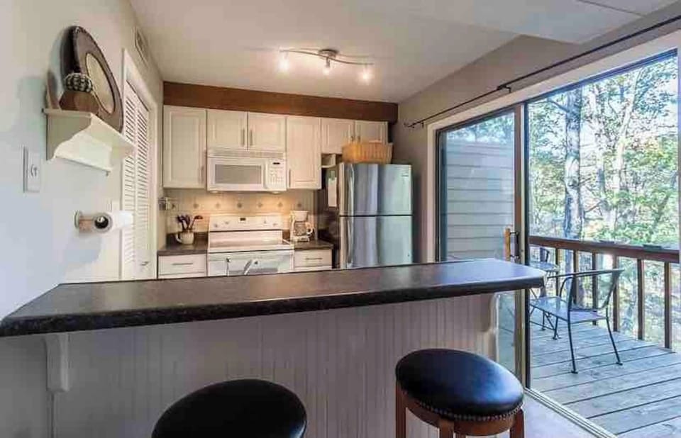 Test out your culinary chops, or pull up a seat for a nice cup of coffee or glass of wine! Pantry in kitchen with in-unit washer/dryer. Easy access to private balcony among the trees! 