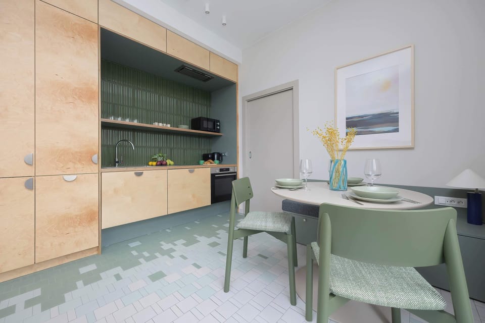 The dining area with designer chairs and subtle lighting creates an elegant space for daily meals and morning coffee.
