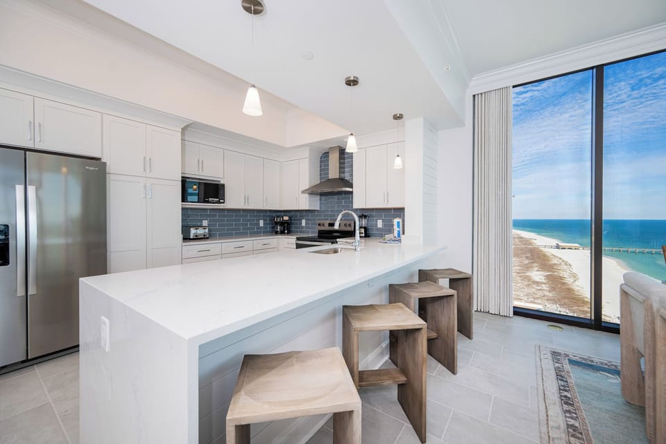 Prepare meals in this stylish kitchen while enjoying views of the beach through large windows