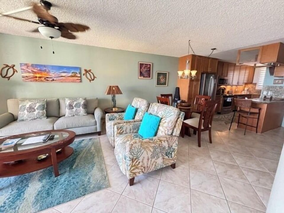 Step into your open-concept retreat where coastal style meets comfort. Relax on plush seating with beach-inspired accents and enjoy the easy flow into your fully equipped kitchen—perfect for preparing meals after sandy adventures.