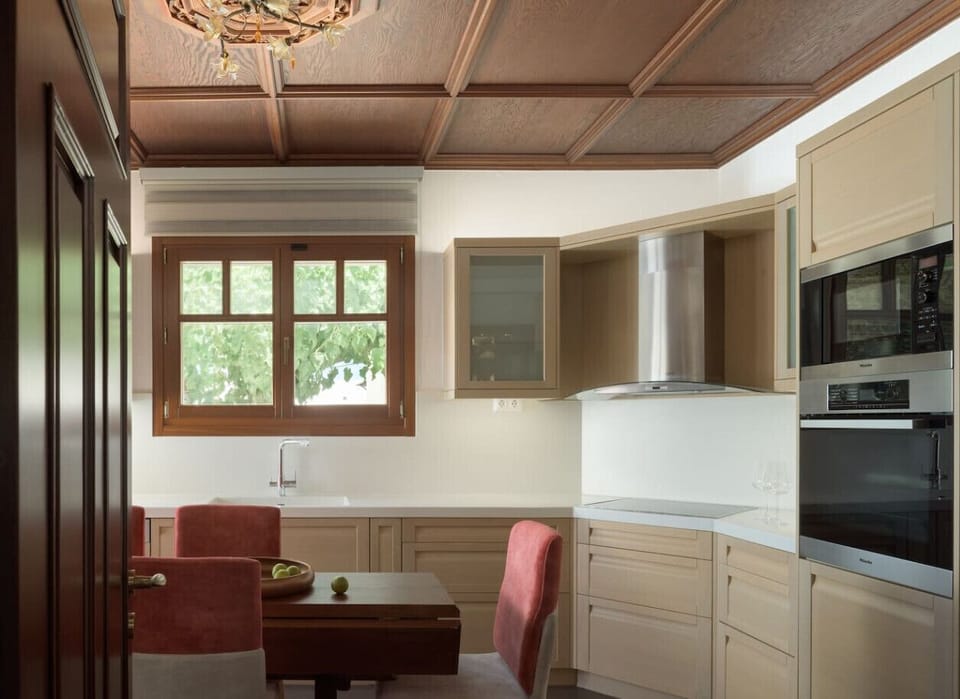 Fully equipped kitchen with dining table and a pool-view balcony.