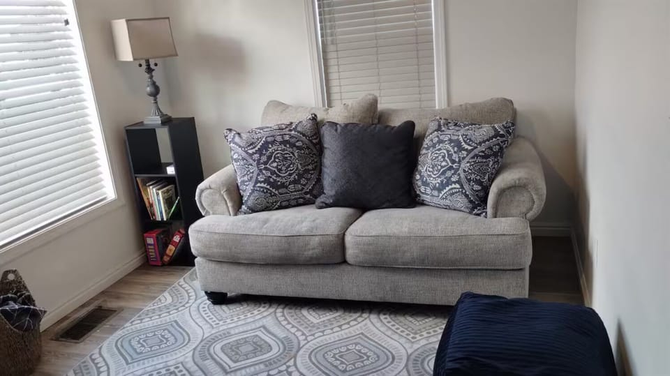 Living room with board games, books for  readers and a tv. 