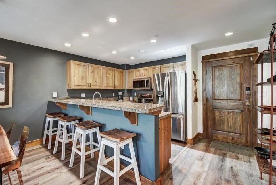 Bar seating and rustic finishes invite casual conversation and laughter—perfect for après-ski snacks or morning coffee with friends.