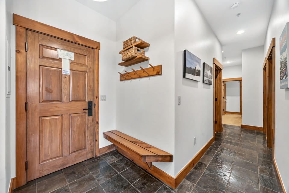 Foyer entry with slate floor and mudroom bench.