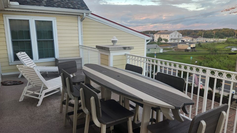 Surfboard dining table for eight and two lounge chairs.  