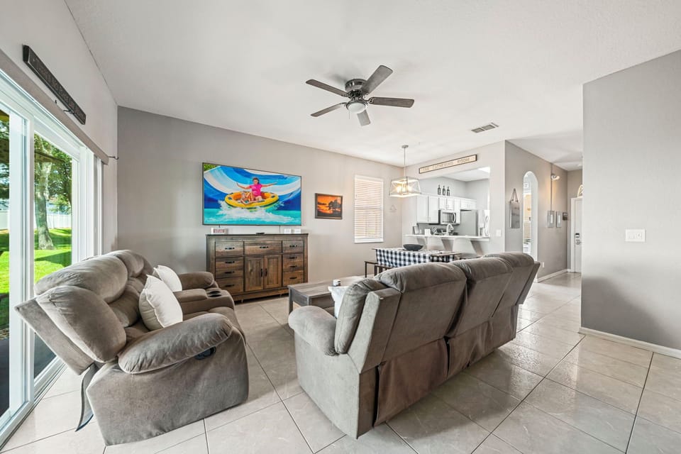 A spacious combined living and dining area with plush carpeting and warm, neutral tones.