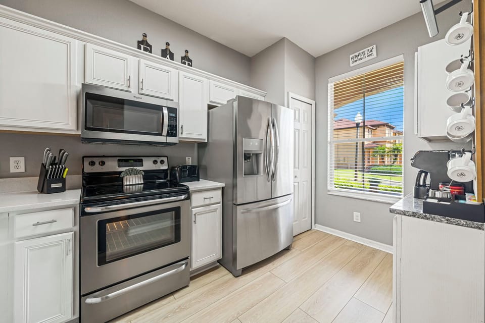 A view of the kitchen entry with clean tile flooring and a practical layout for cooking.