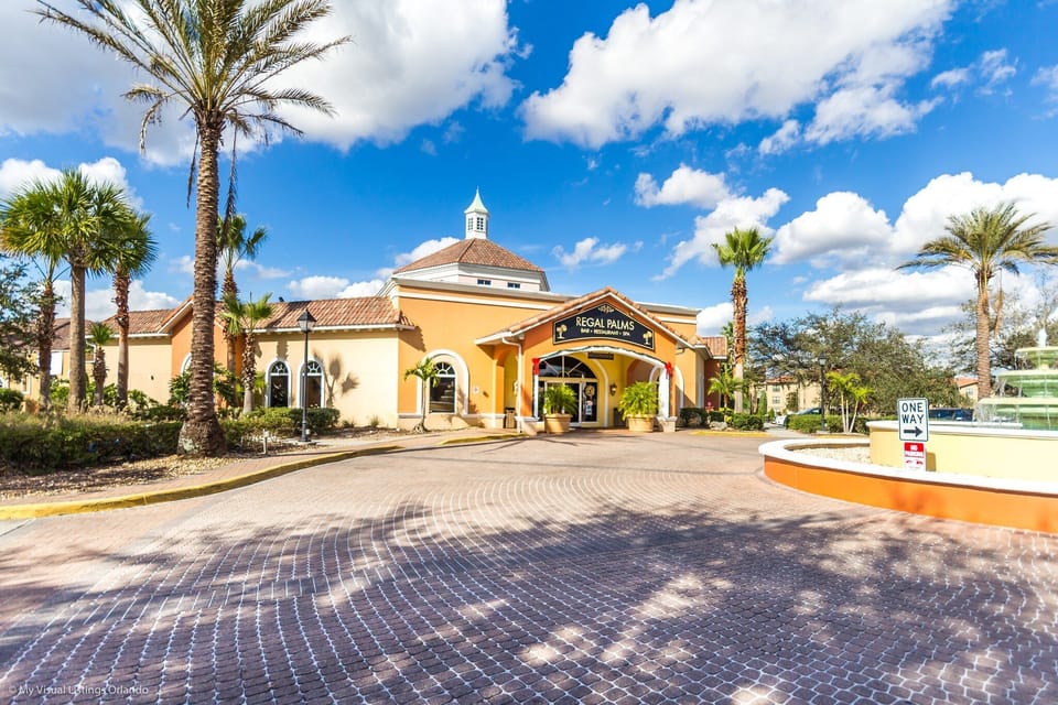 The resort entrance with grand architecture, palm-lined walkways, and a welcoming clubhouse.