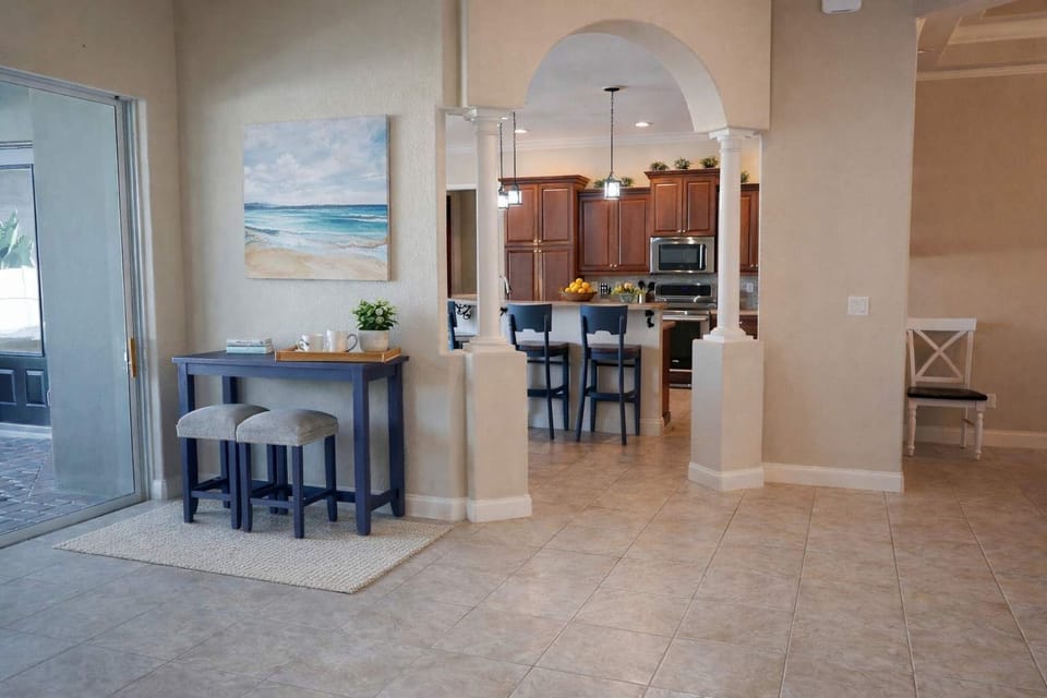 Open kitchen with wooden cabinetry and a breakfast bar with seating.