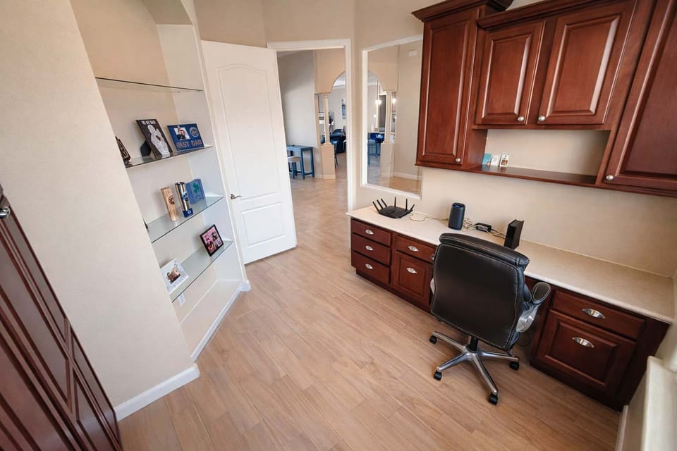 functional home office space with built-in wooden cabinetry and shelving