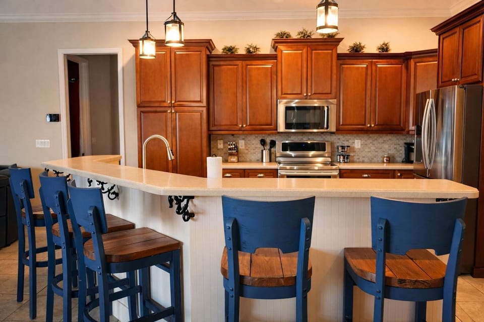 Modern kitchen with wooden cabinetry and a breakfast bar featuring blue stools.