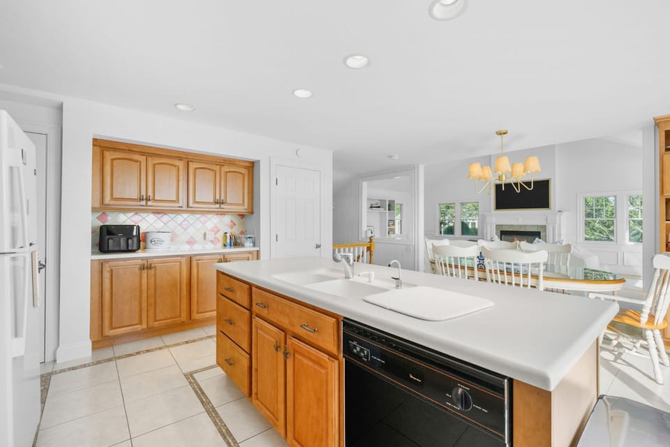 Fully equipped kitchen looking into dining area and living room