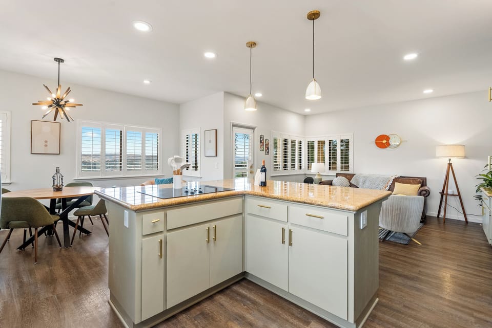 An airy, thoughtfully styled space that connects the kitchen, dining, and living areas seamlessly, ideal for entertaining, everyday comfort, and taking in the stunning natural light throughout.