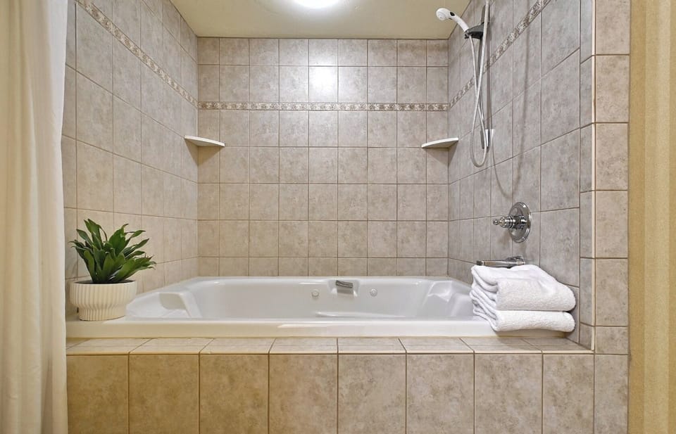 Soak and reset in a deep tub with tiled surround.