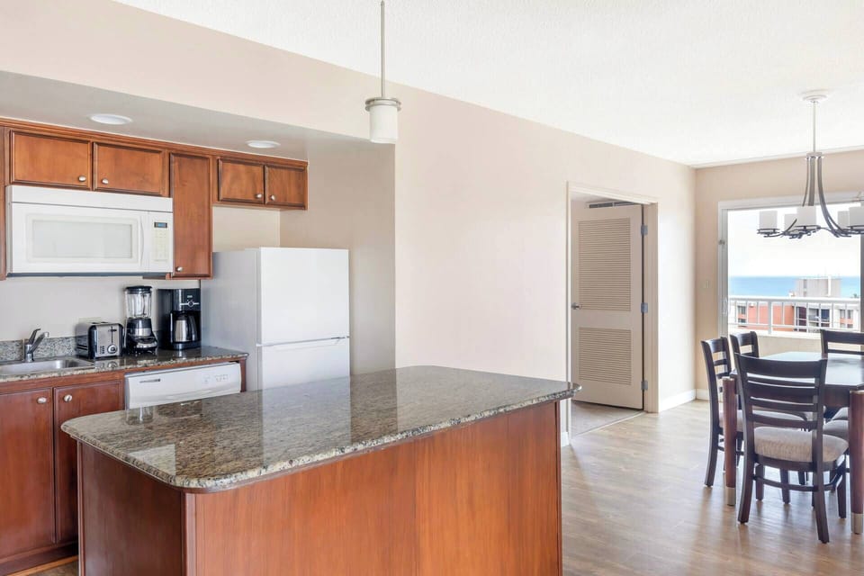 Kitchenette includes apartment-size refrigerator, microwave, dishwasher, coffee maker, toaster, and blender.