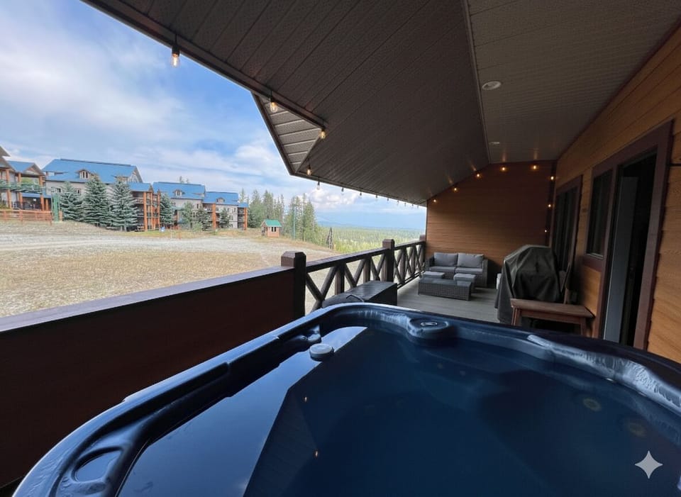 Private deck, with hot tub, seating and Gas BBQ. Overlooks the Owl T Bar and views across to the Rockies.