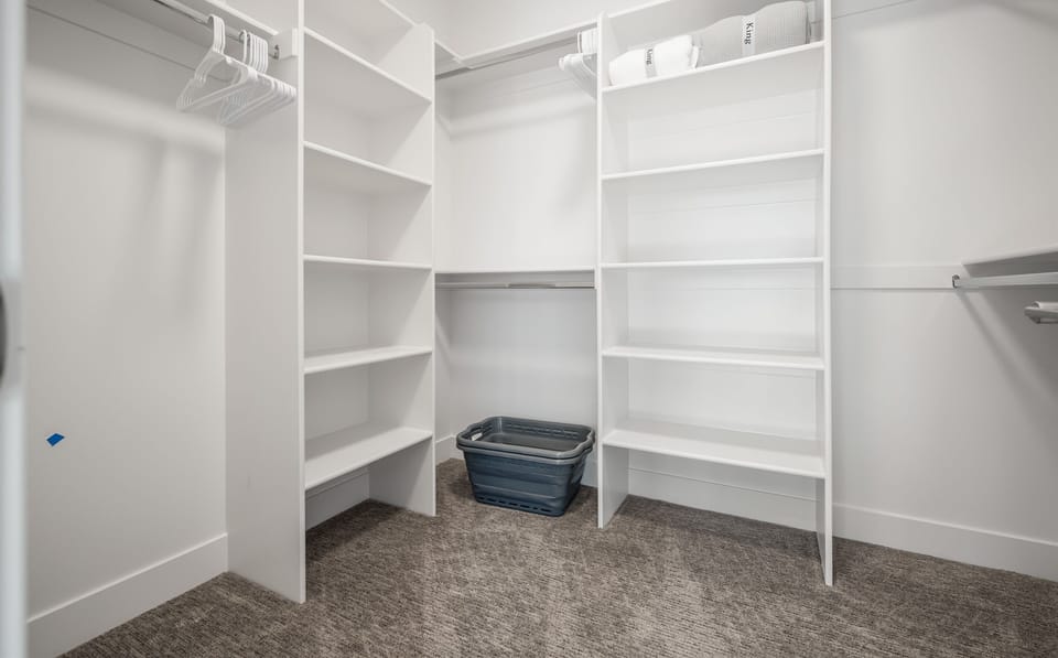 Keep everything organized with a large walk-in closet offering built-in shelving and ample storage.