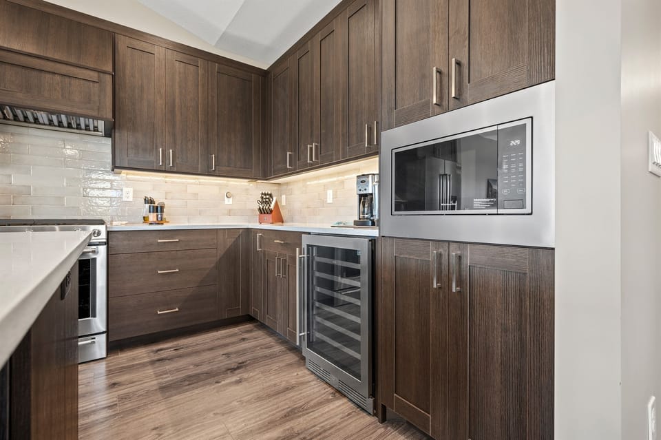 Convenient built-ins like a microwave and wine fridge make entertaining effortless.