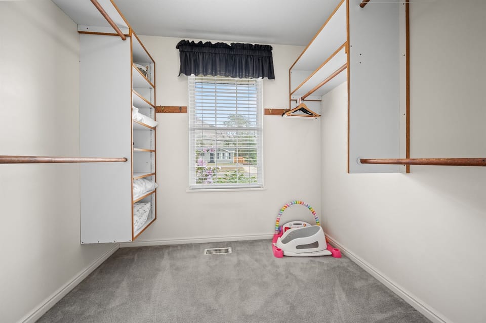 Expansive walk-in closet in the primary suite with plenty of shelving and natural light.