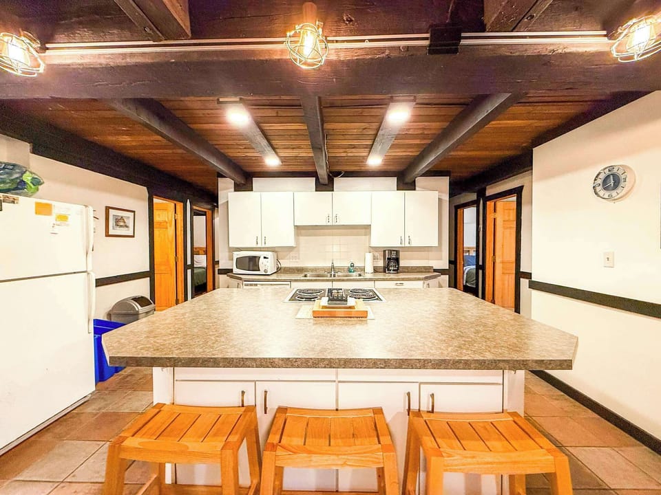 The large kitchen island has a built in stove and oven and three seats for a quick snack before you head out for your day.