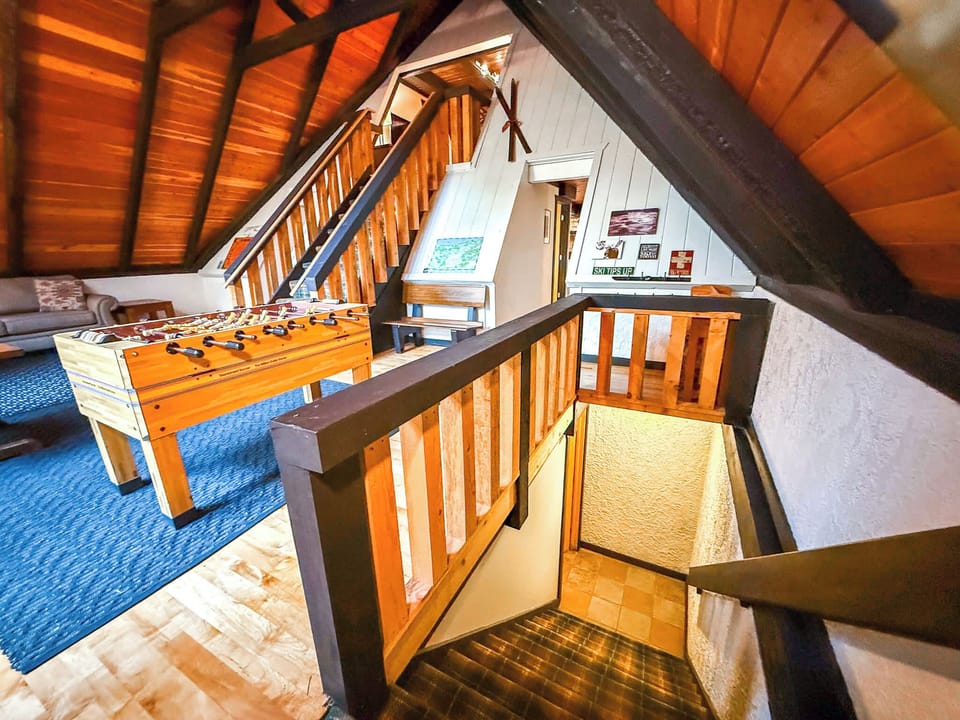 To the right side of the entryway is the other hallway to the rest of the home, as well as the stairs down to the sauna.