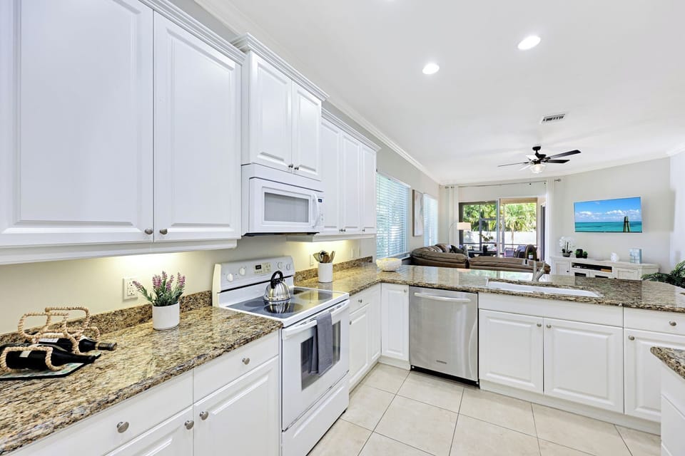 Enjoy easy meal prep with modern appliances and a seamless flow to the living and lanai