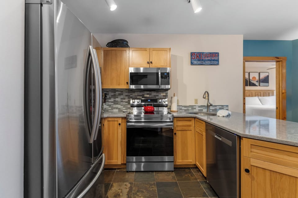 Your fully equipped kitchen awaits with stainless steel appliances and granite countertops, perfect for preparing meals during your mountain getaway.