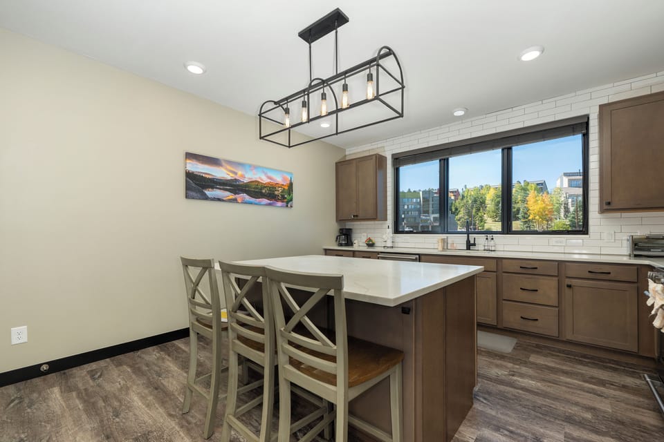 Gather around your spacious kitchen island for morning coffee or evening conversations, with stylish pendant lighting creating perfect ambiance.