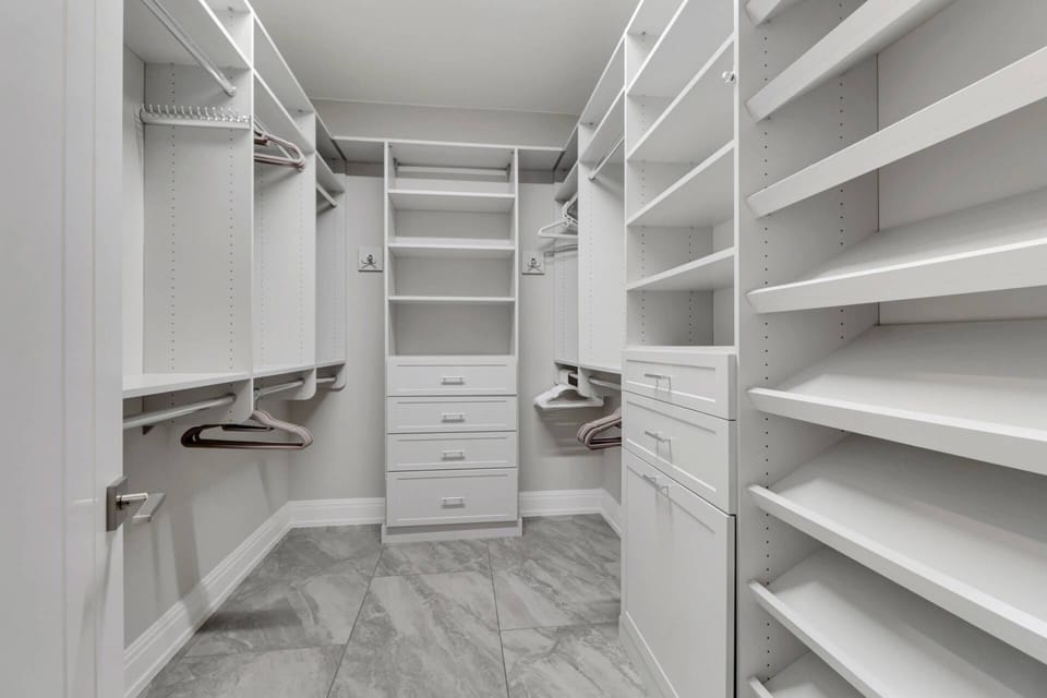 The custom walk-in closet has plenty of room for your belongings, no need to pack lightly.