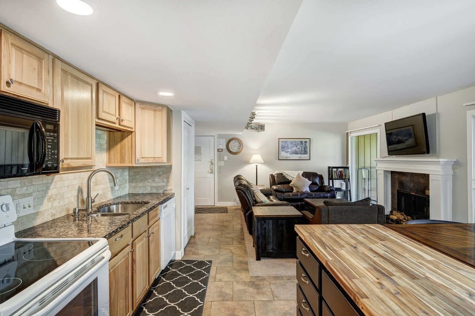 Fully Equipped kitchen with dining counter & modern appliances.