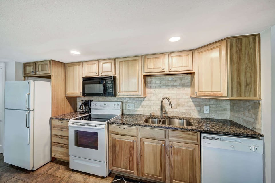 Fully Equipped kitchen with dining counter & modern appliances.
