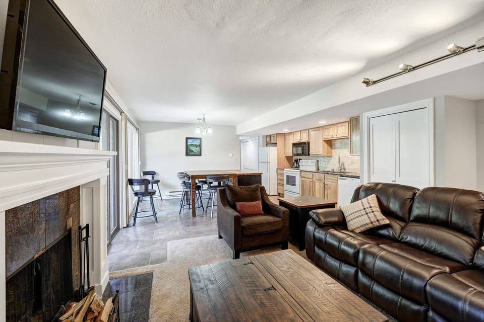Cozy living room with a fireplace, TV, and mountain decor perfect for four guests to relax.