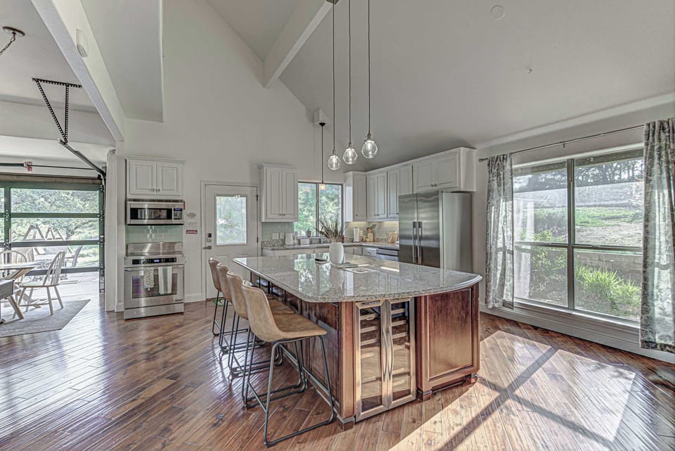 Chef's kitchen with granite counters and stainless appliances 