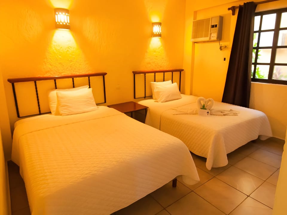 Unwind in a warm, inviting twin room with soft lighting.