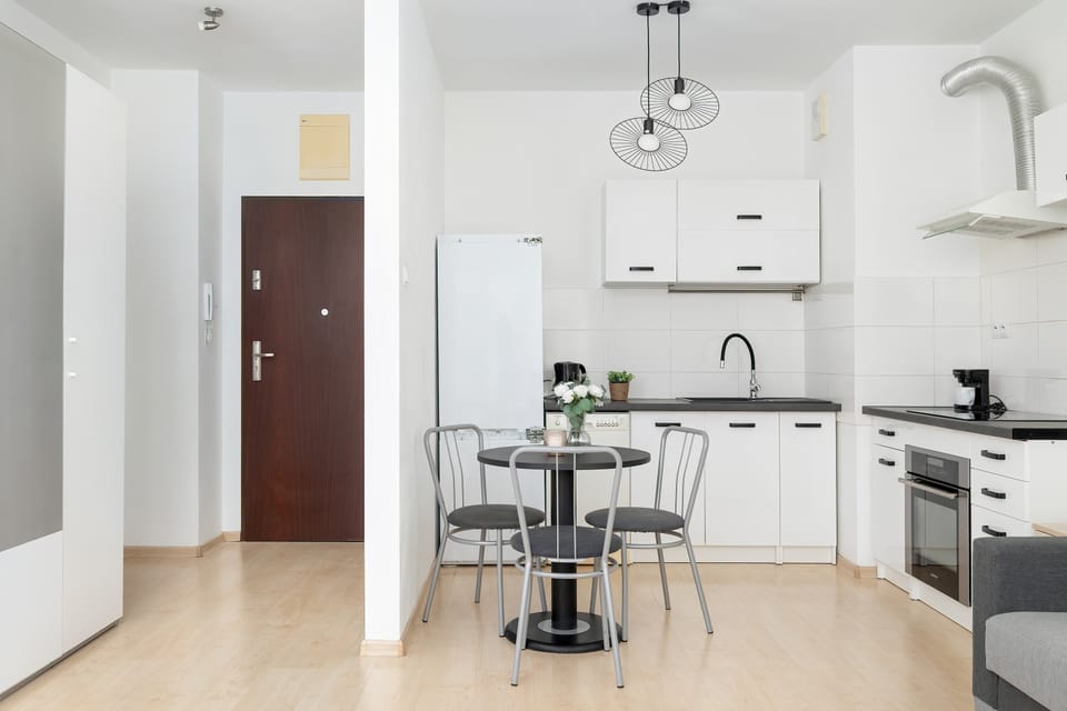 The sleek design of the kitchenette blending seamlessly with the living area.
