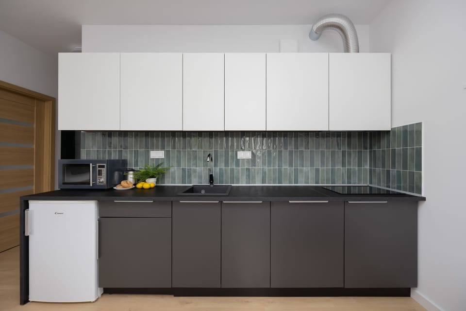 Bright kitchen with cooking utensils. 